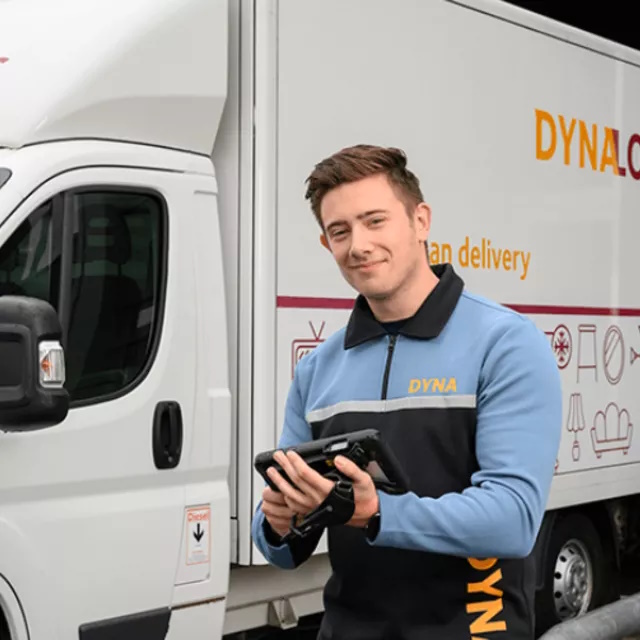 Driver in front of truck holding tablet